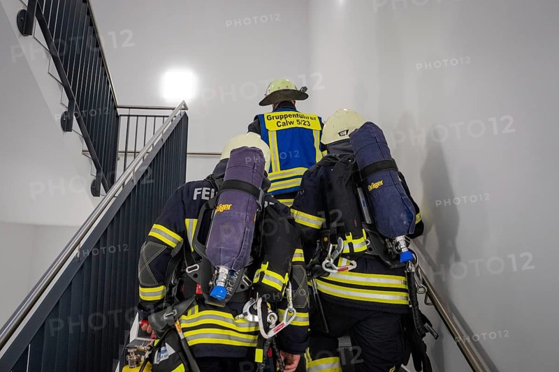 Firefighters climb up the stairwell, ready for their next mission, fire brigade exercise on blue light day in the new Calw hospital, Germany