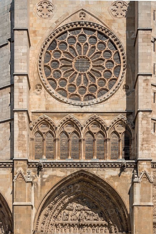 Close-up view of Santa Maria de Regla de Leon Cathedral, showcasing its intricate Gothic architecture, including the ornate rose window and sculpted archways, in Leon, Spain