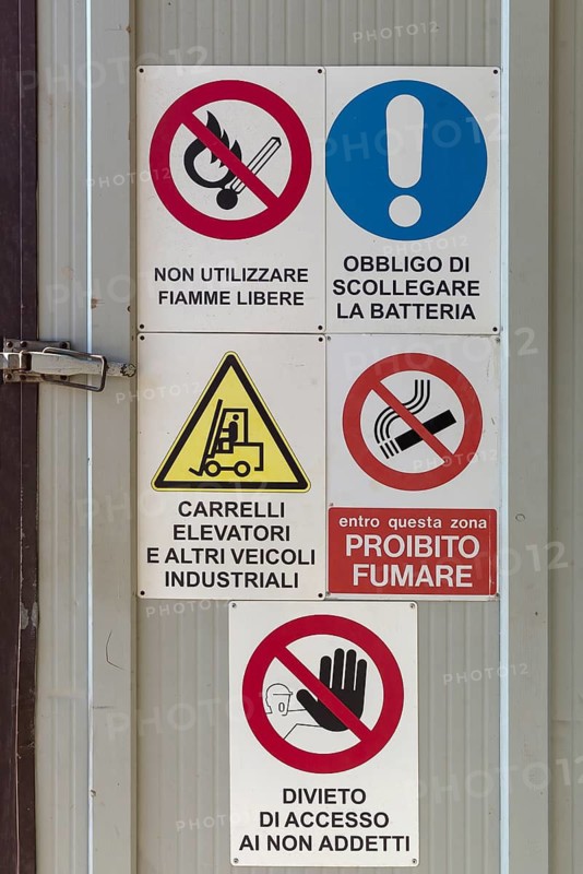 Warning signs on a factory gate, Veneto, Italy