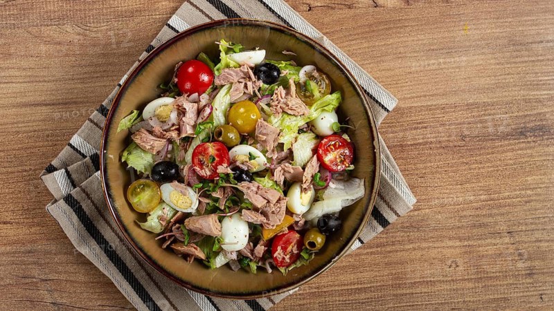 Salad with canned tuna, vegetable salad with quail eggs, lettuce, red onion, cherry tomatoes, olives, keto food, healthy food, homemade, no people