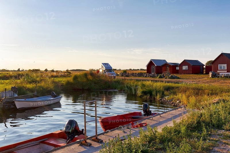 Traditional red fishing huts, holiday homes on the Baltic Sea coast, fishing port, campervan, coastal landscape, evening sun, bodudden, Löt, Öland island, Kalmar län, Sweden