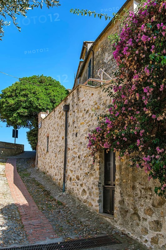 Picturesque narrow alley and wall on the edge of the medieval old town of Cervo, province of Imperia, Liguria, Italy