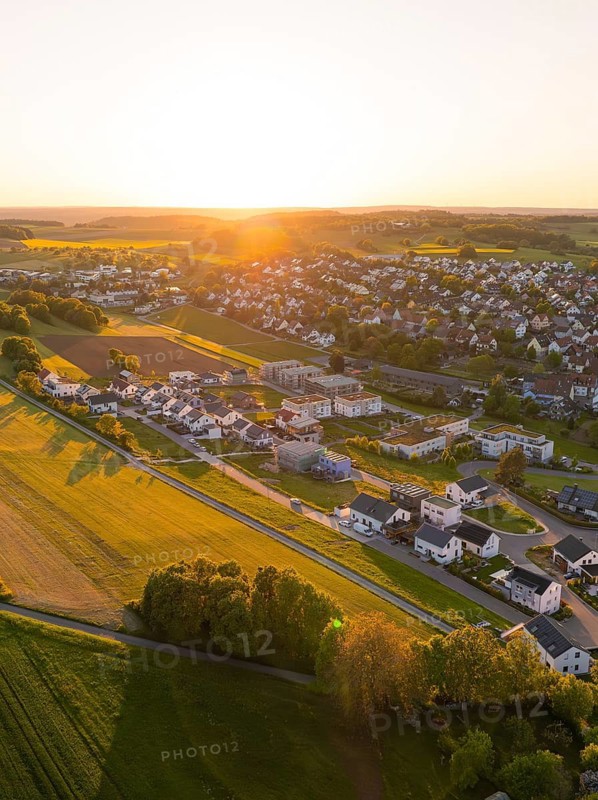 Aerial view of a quiet village surrounded by fields at sunset, Gechingen, Black Forest, Germany