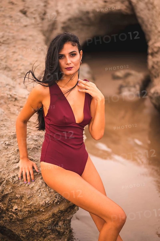 Young caucasian brunette with a maroon swimsuit, summer on the beach of Cabo de Gata, Nijar. Andalucia, Spain
