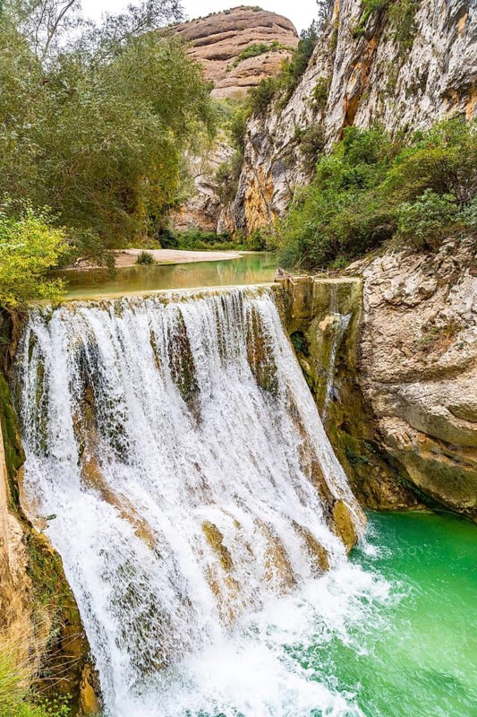 Waterfall next to the path on the Vero River walkways in Alquezar. Huesca Pyrenees