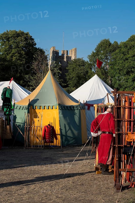 Colourful round tents, man in medieval clothing, medieval market, medieval week, fortified defence tower, former Hanseatic city of Visby, UNESCO World Heritage Site, Gotland Island, Sweden
