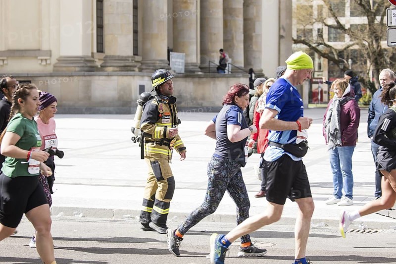 Runners in fire brigade gear at the 44th Generali Berlin Half Marathon 2025 in Berlin on 6 April 2025