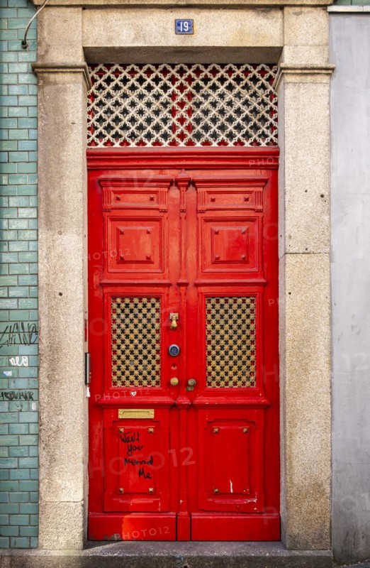 Close-up of vividly red doors on the historical façade in the Ribeira district, Porto, Portugal