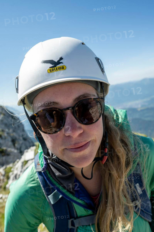 Mountaineer with helmet looks into the camera, Wetterstein Mountains, Bavaria, Germany