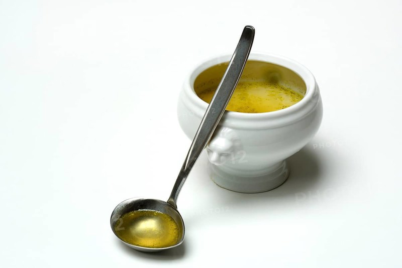 Bouillon, vegetable broth with ladle and bowl