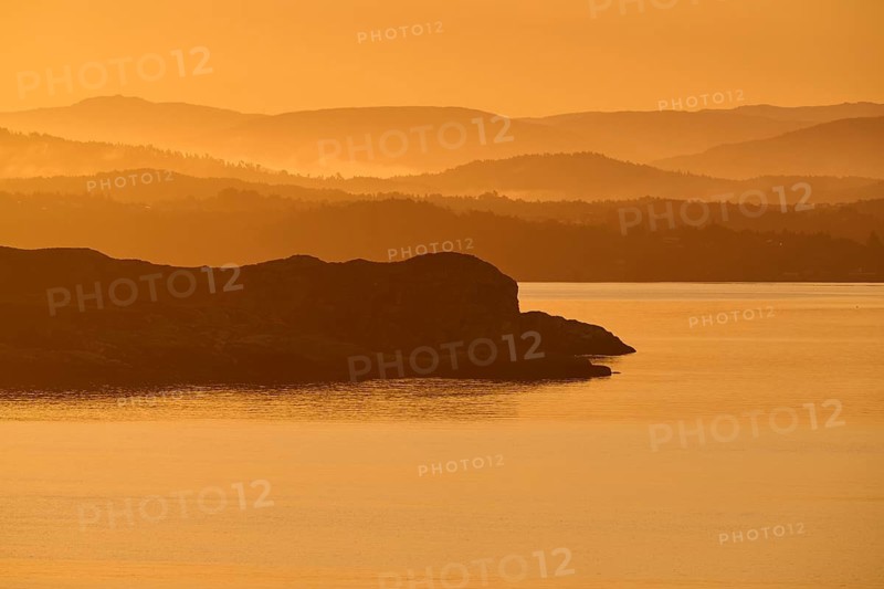 Atmospheric landscape scene at sunrise, landscape in twilight with soft fog, autumn, Bergen, North Sea, Norway