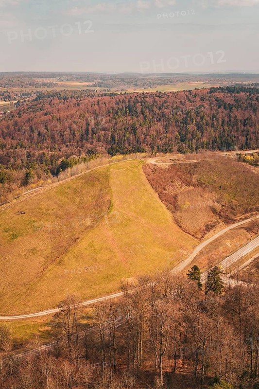 Aerial view of a hilly landscape with forest, fields and a hiking trail in autumn atmosphere, old deposit in front of PV Bau, Lindenrain, Calw, Germany