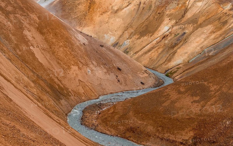 Steaming stream between colourful rhyolite mountains, Hveradalir geothermal area, Kerlingarfjöll, Icelandic highlands, Iceland