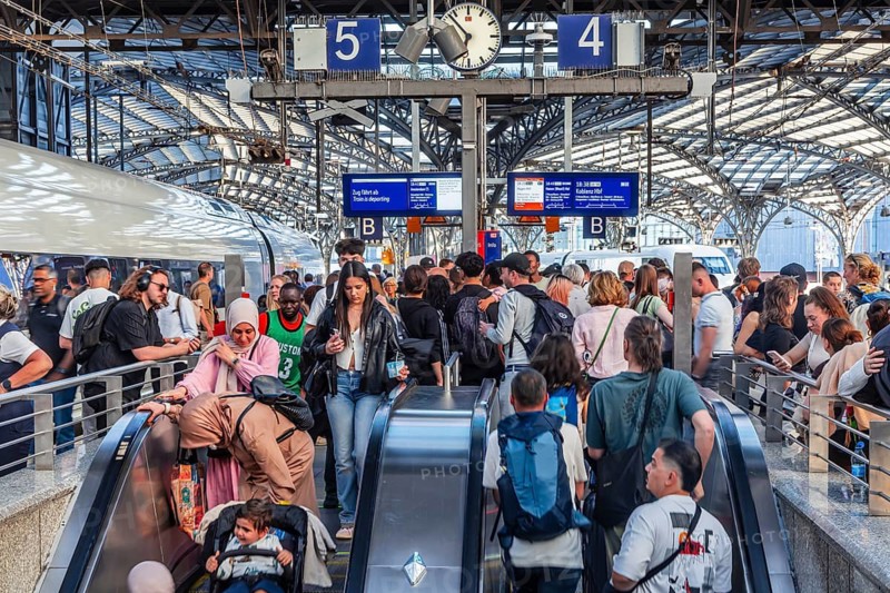 Cologne Central Station. Stairs to the platforms. Travellers waiting for their train on the platform. Crowd with motion blur. Cologne, North Rhine-Westphalia, Germany