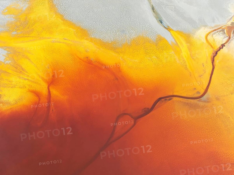 Waste pond in the mineral-rich area of the Rio Tinto mines. The colour is caused by oxidised iron minerals. Aerial view. Drone shot. Huelva province, Andalusia, Spain