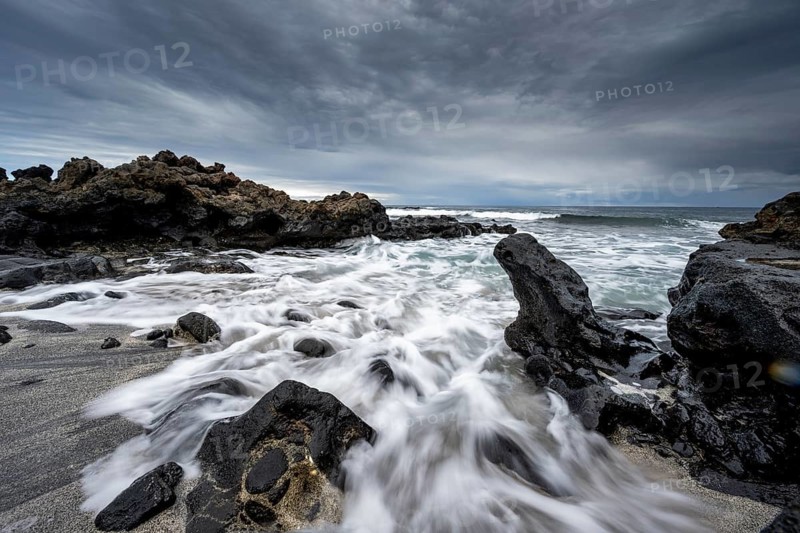 Waves blaze on the beach, rocky coast with volcanic stones, long exposure, Playa de la Pequeña, Punta Usaje, Lanzarote, Canary Islands, Spain