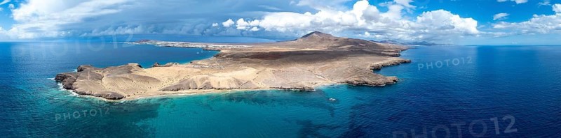Headland and blue sea, coastal landscape, arid landscape of Los Ajaches Natural Park, aerial view, Lanzarote, Canary Islands, Spain