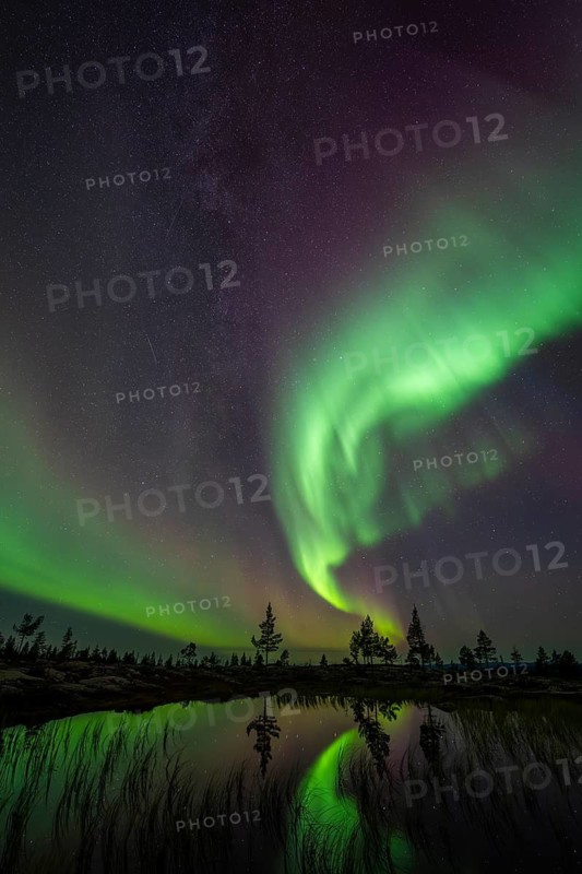 Northern Lights (Aurora borealis) reflected in a mountain lake, Norrbotten, Lapland, Sweden, September 2024