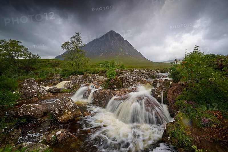 Dramatic landscape with stormy sky, wild river and strong waterfalls in front of a gloomy mountain, Buachaille Etive Mor Viewpoint, River Coupall, Glen Etive, Scotland, United Kingdom, Great Britain