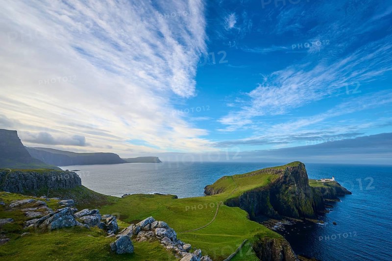 Wide angle view of a coastal landscape with cliffs under a dramatic sky, Neist Point Lighthouse, Waterstein, Isle of Skye, Scotland, United Kingdom, Great Britain
