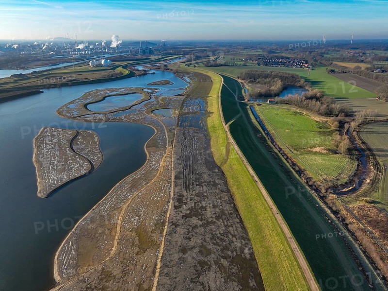 Haltern-Marl, North Rhine-Westphalia, Germany - Lippe, flood protection in the Haltern-Lippramsdorf-Marl area (HaLiMa) . Flood protection on the River Lippe by relocating the dyke and thus extending the floodplain. On the right, the completed floodplain north, the north dyke. Work is still underway on the south dyke. Marl Chemical Park in the back