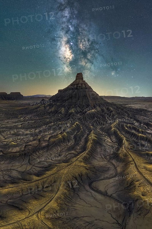 Spectacular view of the Milky Way galaxy illuminating a rugged sandstone desert landscape in Utah, United States. Captivating night sky scene with breathtaking celestial display