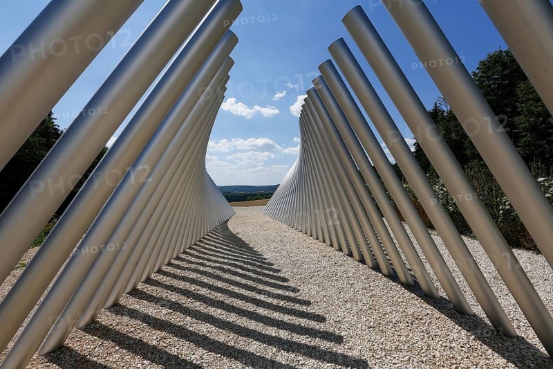 Art in public space, sculpture made of aluminum profile pipes by artist Martin Burchard, life's horizon path near Mundingen, light and shadow, gravel, clouds, blue sky, walk-in art, paths of reflection and refreshment on the Ehinger Alb, Baden-Württemberg, Germany