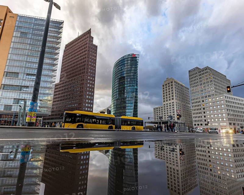 Potsdamer Platz Berlin in the evening with traffic on the streets. When it rains, the skyscrapers are reflected in puddles of water. Berlin, Germany