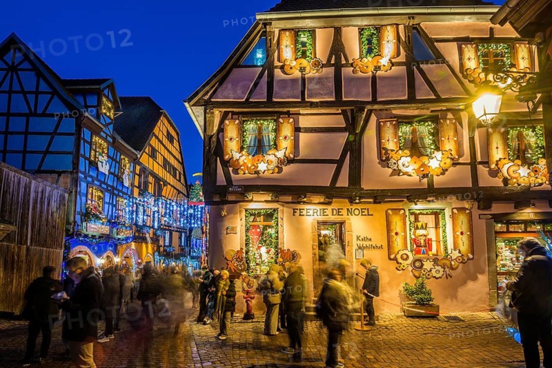 Colour-illuminated and Christmassy decorated half-timbered houses, blue hour, Christmas market, Riquewihr, Grand Est, Haut-Rhin, Alsace, France