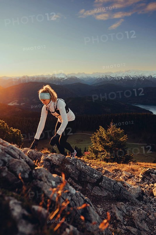 Trail running in autumn on the Jochberg on Lake Walchensee against the wonderful backdrop of the Alps, Bavaria, Germany