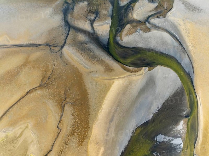 Streams and marshes at low tide in the wetlands of the Walvis Bay lagoon. Aerial view. Drone shot. Walvis Bay, Namibia