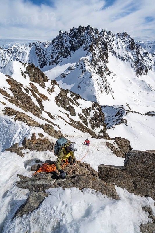 Mountaineer belaying on a steep snow slope, belaying on a rope, ascent to the summit of Piz Grialetsch in winter, view of mountain panorama with snow, Grisons Haute Route, Albula Alps, Rhaetian Alps, Grisons, Switzerland