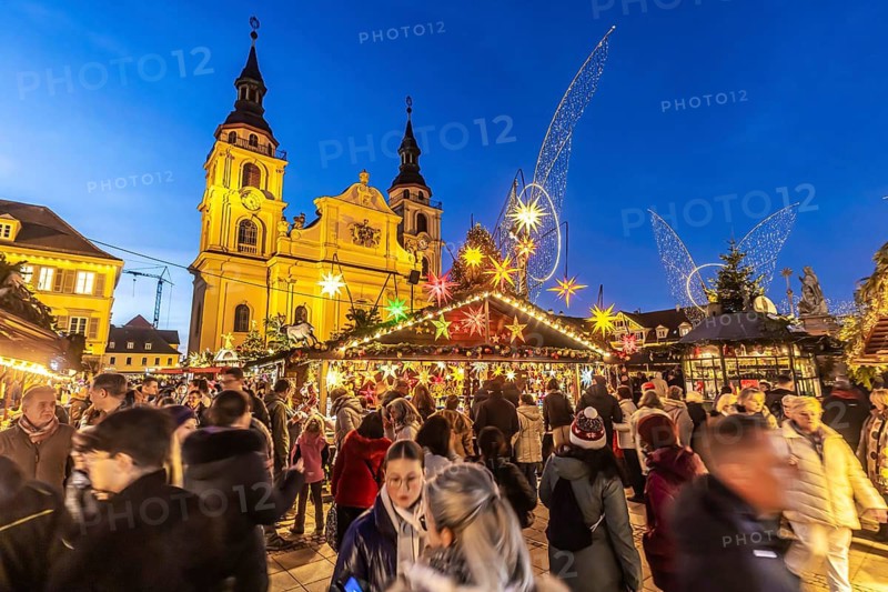 Baroque Christmas market with illuminated angels between the Protestant City Church and the Catholic Church of the Most Holy Trinity. Sights on the market square in the evening. Ludwigsburg, Baden-Württemberg, Germany