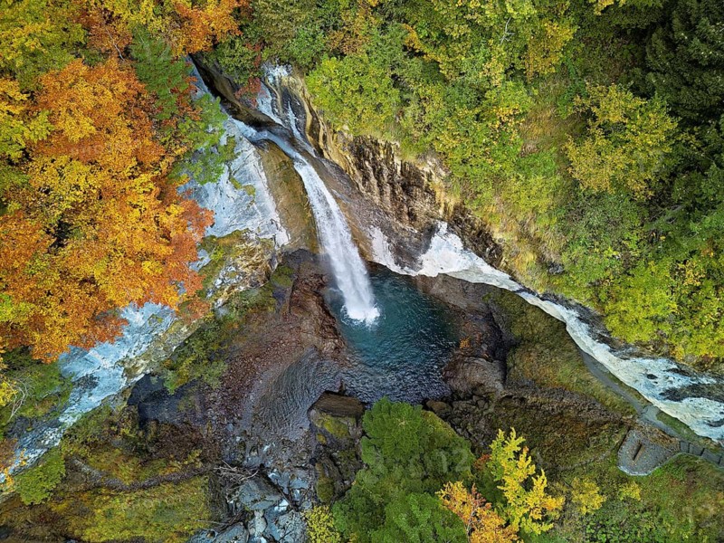 Aerial view of Berglistüber waterfall in autumn-colored surroundings, Linthal, Klausenpass, Canton of Glarus, Switzerland