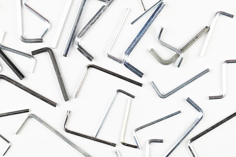 Various L-shaped Allen wrenches scattered on a bright surface
