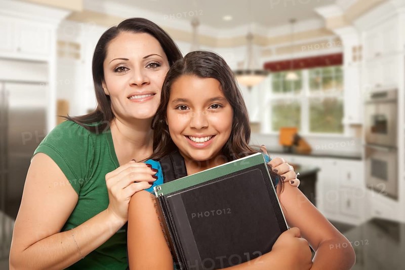 Proud Hispanic Mother and Daughter In Kitchen at Home Ready for School