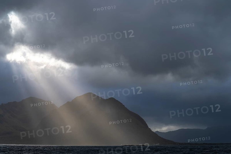 Sunbeams over coastal landscape and sea, Lofoten, Nordland, Norway, September 2020
