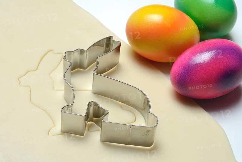 Rolled dough with bunny cookie cutter and easter eggs