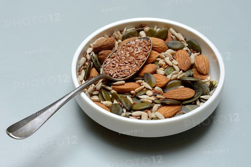 Seeds in bowls, mix of almond seeds, sunflower seeds, linseeds and pumpkin seeds