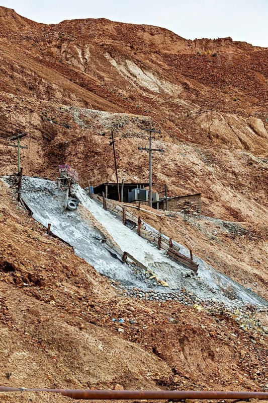 Abandoned entrance to a mine in an earthy, barren slope, The silver mines of Potosi on Cerro Rico in Bolivia