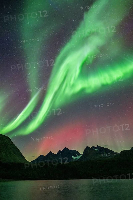 Northern lights over Bergen in the Lyngen Alps, reflection on the lake, Troms og Finnmark, Norway
