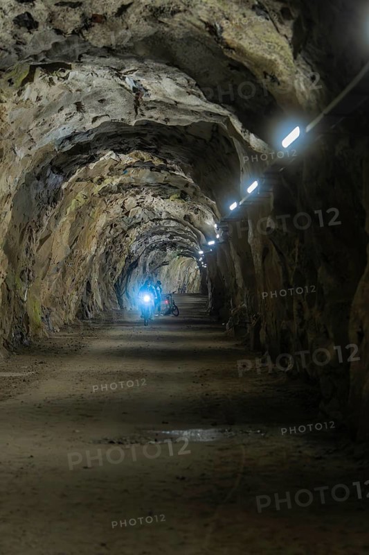 Stony tunnel with artificial lighting in an underground cave, Klein Tibet, Zillertal, Austria