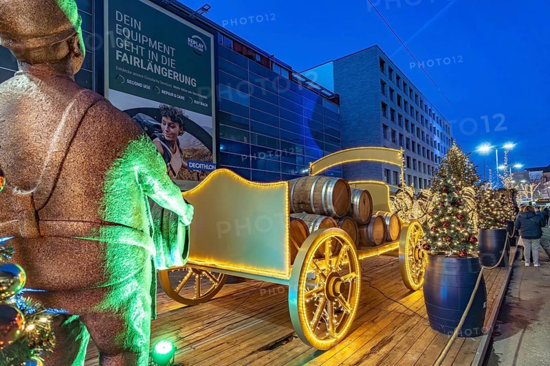 Light installation beer carriage with horses at Dortmund's Christmas market at dusk, Dortmund, North Rhine-Westphalia, Germany