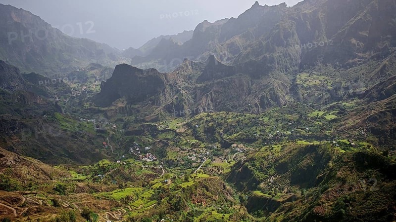 Panoramic, spectacular view over a valley with a winding path, hiking trail and mountains in the background under foggy conditions, hiking from Cova Crater through Paul Valley, Ribeira do Paul to Vila das Pombas, Santo Antao, Cabo Verde, Cape Verde, Cape Verde