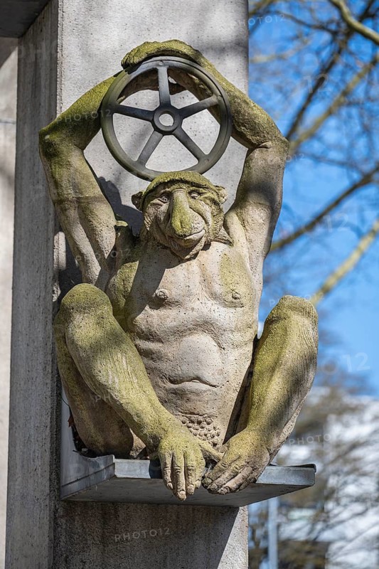 Sculpture by sculptor Peter Lenk at the Arc de Triomphe on the Lower Arbor depicts an ape-like person holding a steering wheel over his head, depicting a caricature of a car driver. Konstanz, Konstanz District, Baden-Württemberg, Germany