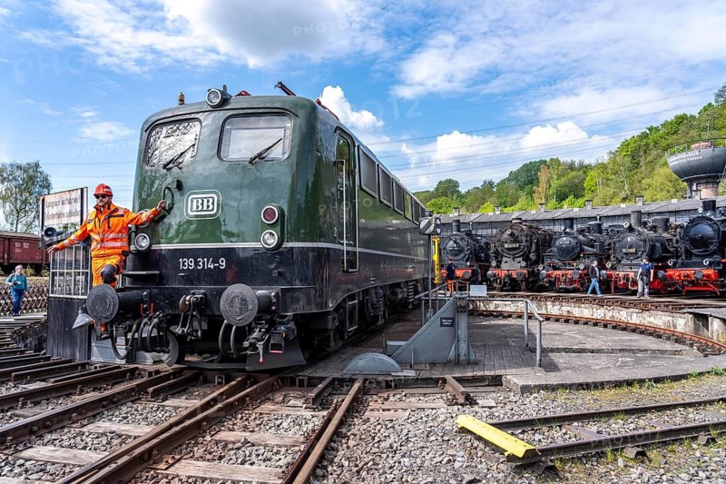 Freight train electric locomotive E 40 1314 at the ring locomotive shed with many historic steam locomotives in the Bochum Railway Museum, museum days weekend, with many attractions such as steam locomotive rides, 3 locomotives are under steam, historic trains make round trips through the Ruhr Valley, many locomotives can be visited, on the site of the former Dahlhausen railway depot, North Rhine-Westphalia, Germany