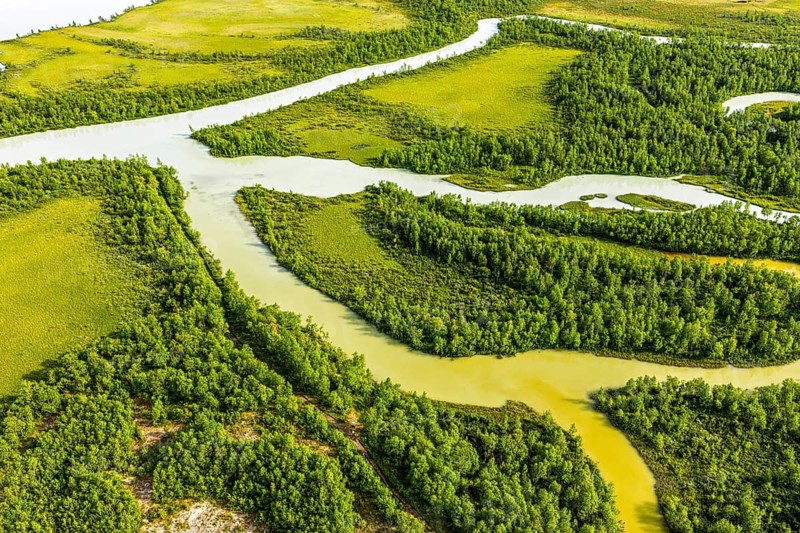 Aerial view of river near Nikkaluokta, muddy river branches cut into the wetland at lake Laukkujärvi, Nikkaluokta, Sweden
