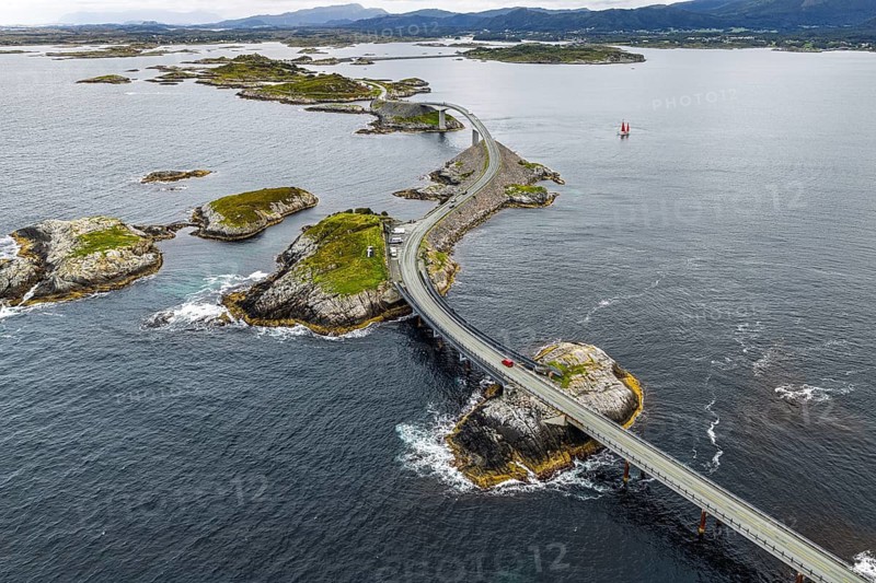 Aerial view of the Atlantic Ocean Road (Atlanterhavsveien), red sailing boat, Norway