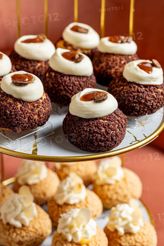 A tempting array of choux pastries sits elegantly on a gold tiered stand. Topped with creamy icing and garnishes, these delectable treats are perfect for tea parties or gatherings
