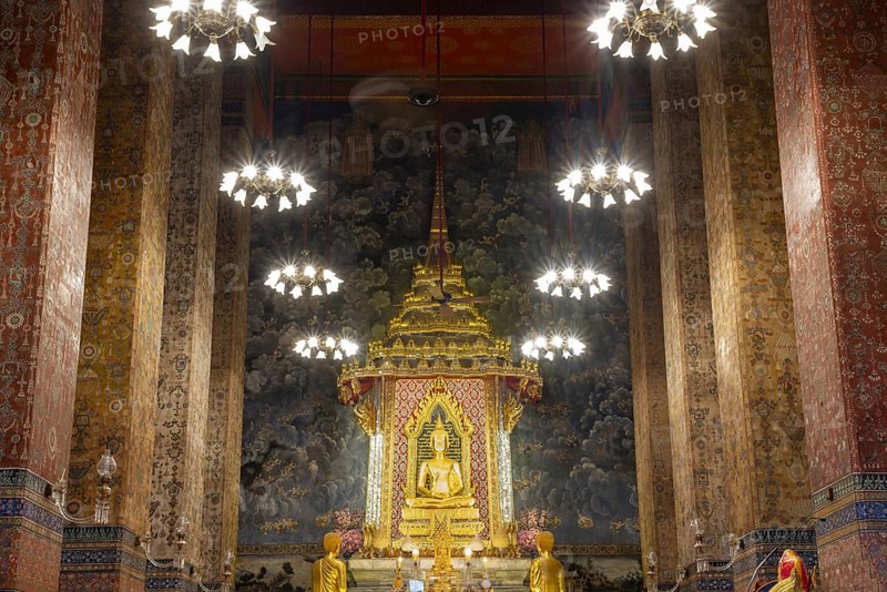 Golden meditating Buddha surrounded by wall paintings with Buddhist teachings and representations of Buddha's disciples, Wat Makut Kasatriyaram Ratchaworavihan, Phra Nakhon District, Old Bangkok, Thailand